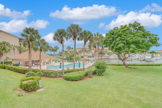 view of yard featuring a water view and a community pool