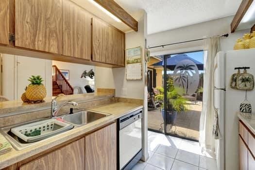 kitchen with sink, white appliances, and light tile patterned floors