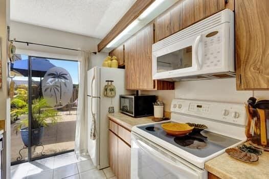 kitchen featuring white appliances and light tile patterned floors