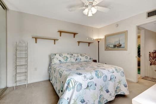 carpeted bedroom with ceiling fan