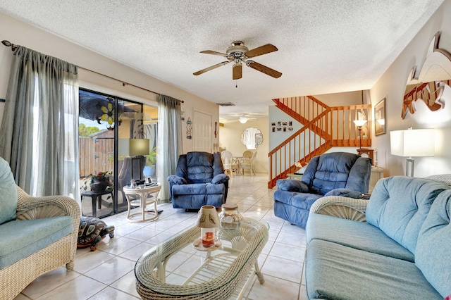 tiled living room featuring a textured ceiling and ceiling fan