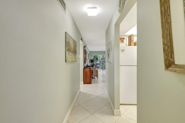 hall featuring light tile patterned floors