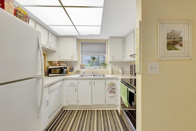 kitchen with white cabinetry, stainless steel appliances, and sink