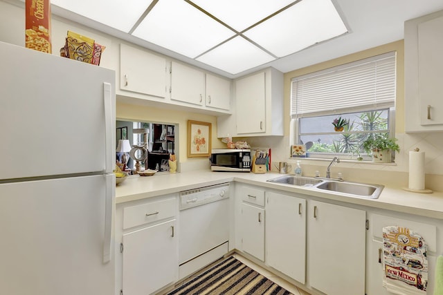 kitchen featuring tasteful backsplash, white appliances, sink, and white cabinets