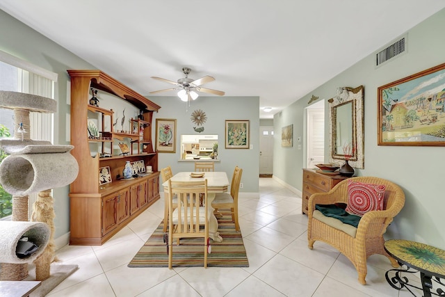 tiled dining area with ceiling fan