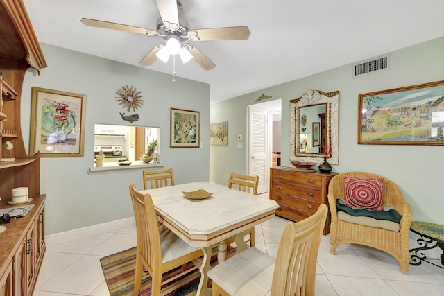 dining space with light tile patterned floors and ceiling fan