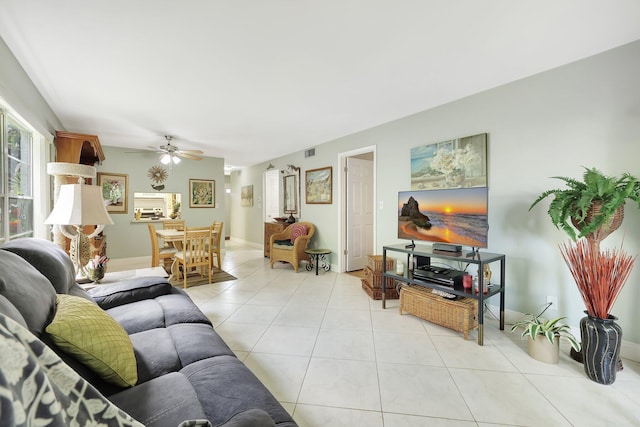 living room with ceiling fan and light tile patterned flooring