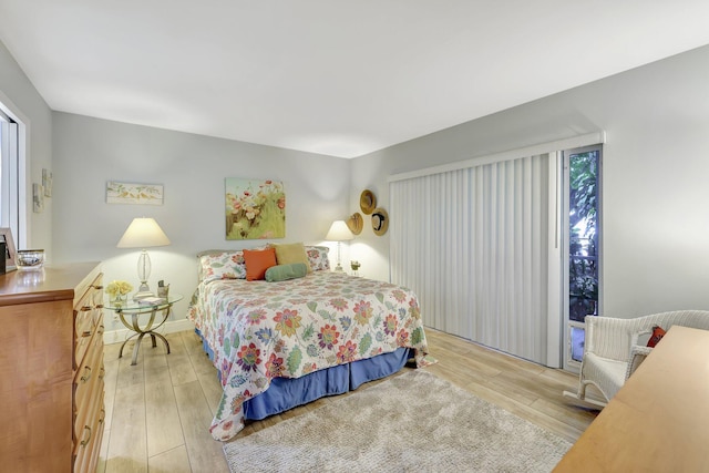 bedroom featuring light hardwood / wood-style flooring and access to outside