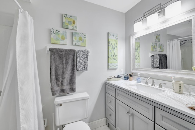 bathroom featuring walk in shower, vanity, and toilet