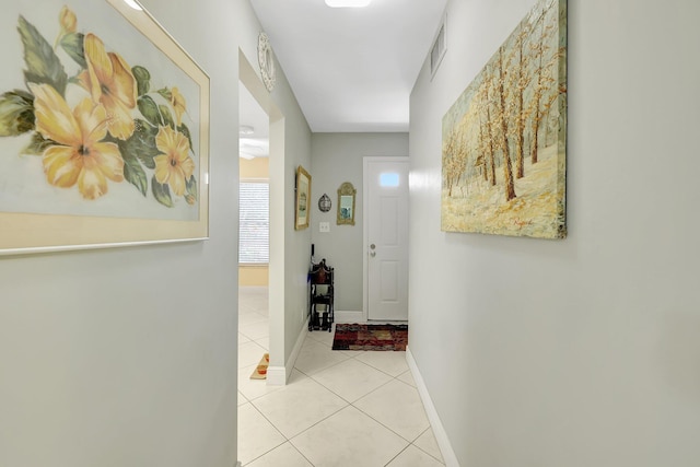 hall featuring light tile patterned flooring