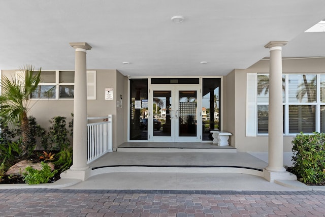 entrance to property with french doors and stucco siding