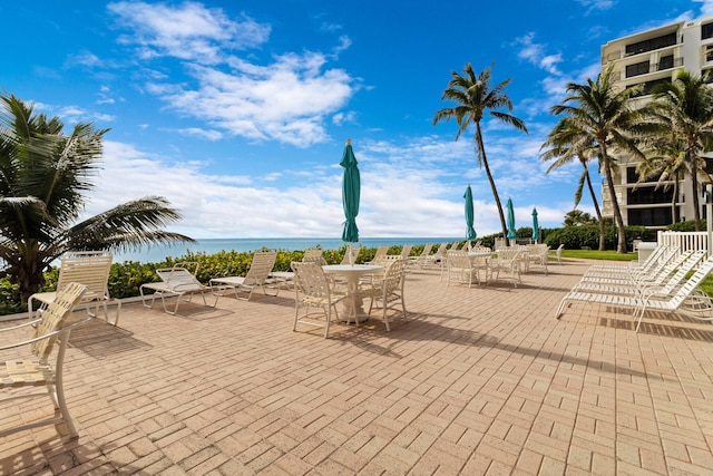 exterior space featuring a water view and a patio