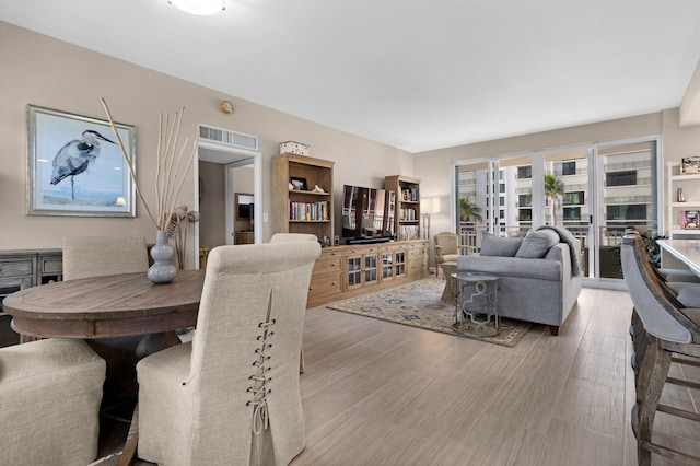 living room featuring french doors and light hardwood / wood-style floors