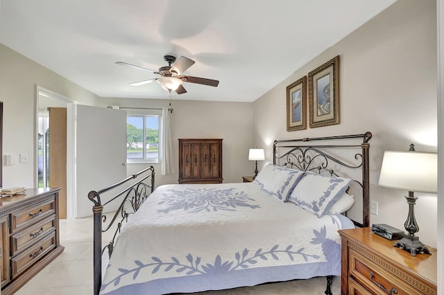 tiled bedroom featuring ceiling fan