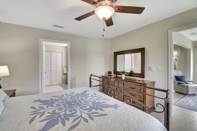 tiled bedroom featuring ceiling fan