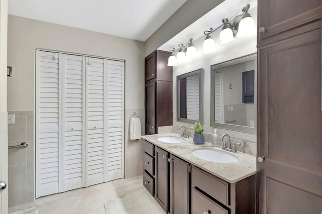 bathroom featuring tile patterned flooring and dual bowl vanity