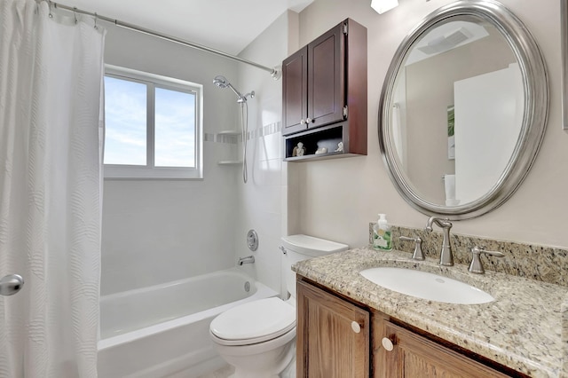 full bathroom with vanity, shower / bath combo, and toilet