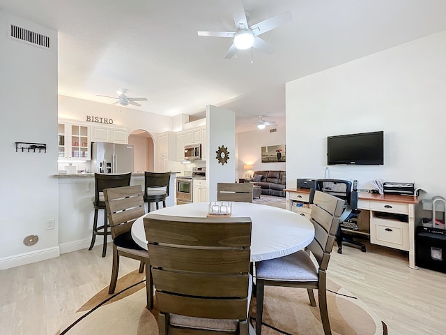 dining area featuring ceiling fan and light wood-type flooring