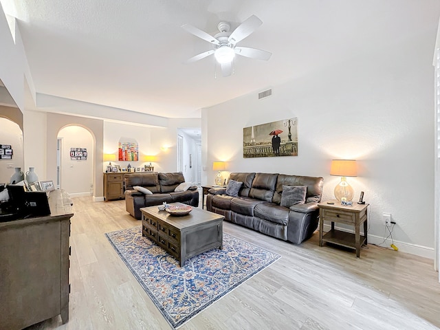 living room featuring ceiling fan and light hardwood / wood-style floors