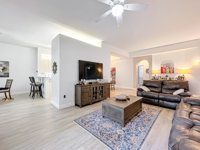 living room with ceiling fan and light hardwood / wood-style floors