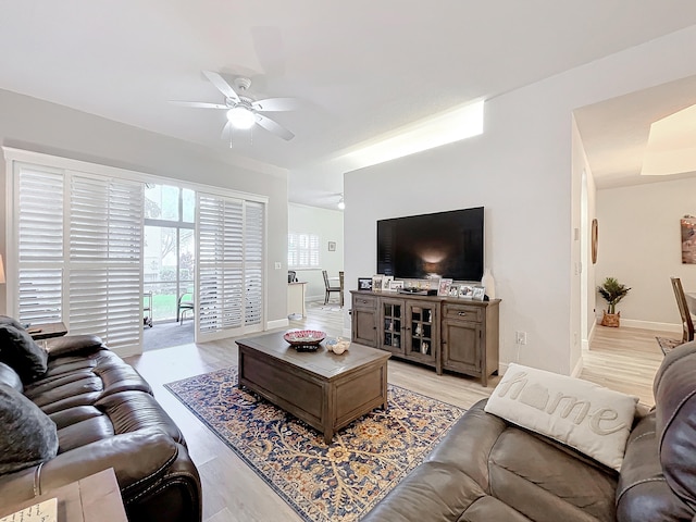 living room with ceiling fan and light hardwood / wood-style floors