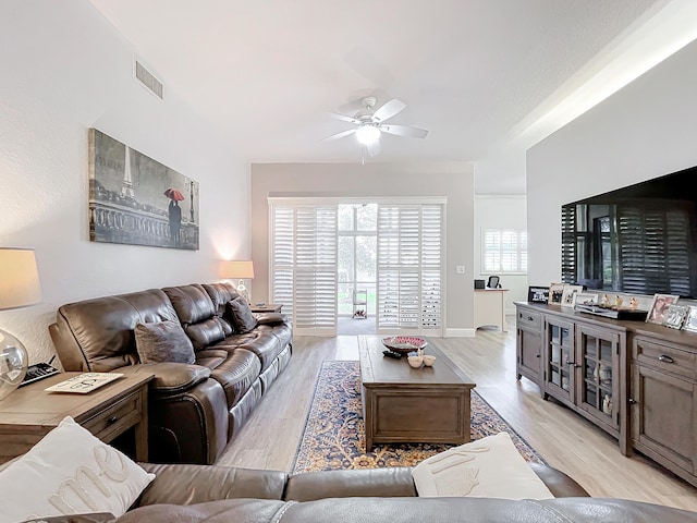 living room featuring ceiling fan and light hardwood / wood-style floors