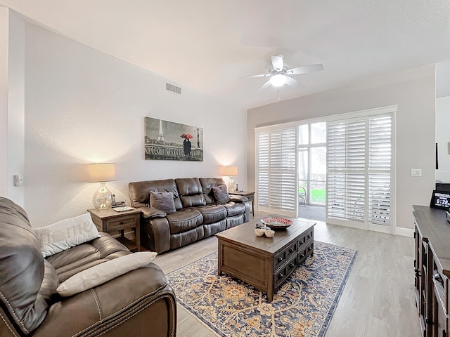 living room with light wood-type flooring and ceiling fan