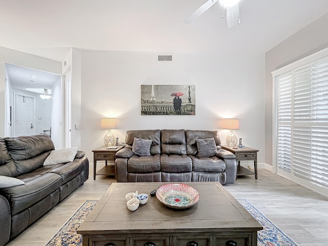 living room featuring ceiling fan and light hardwood / wood-style floors