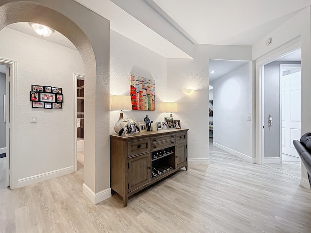 corridor with light hardwood / wood-style flooring