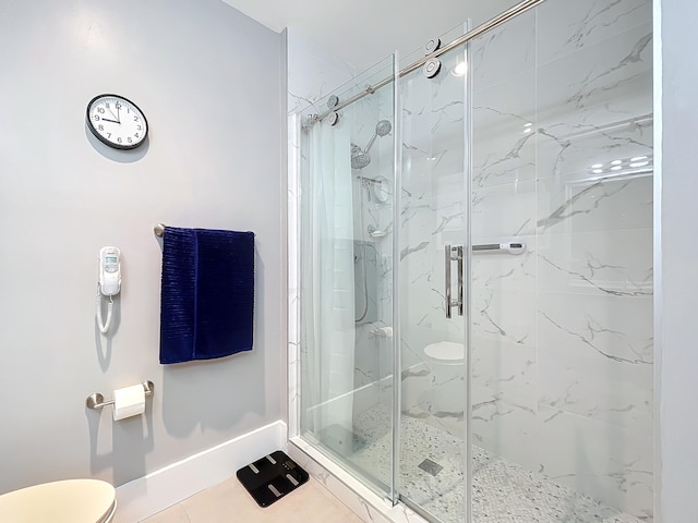 bathroom with an enclosed shower, toilet, and tile patterned flooring