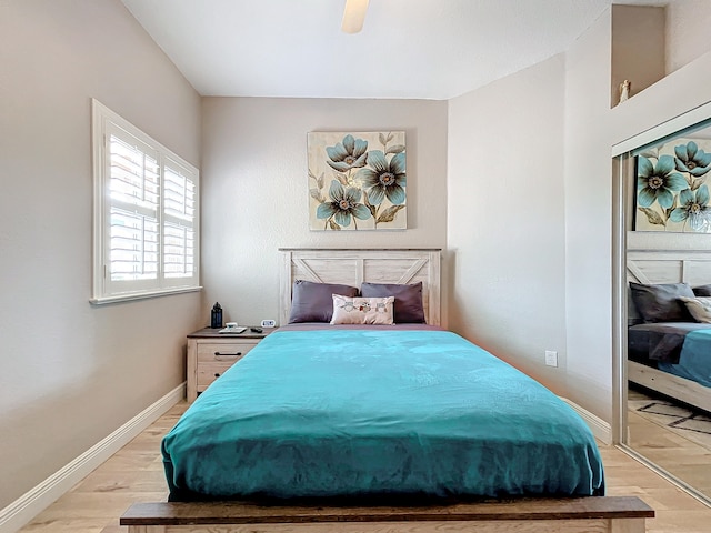 bedroom with a closet, ceiling fan, and light hardwood / wood-style floors