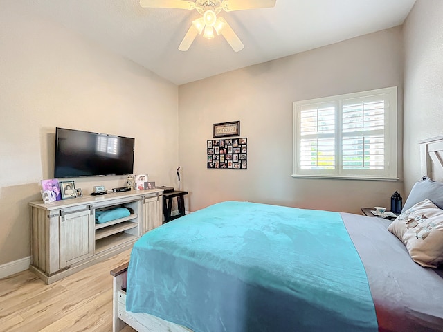 bedroom with ceiling fan and light hardwood / wood-style floors