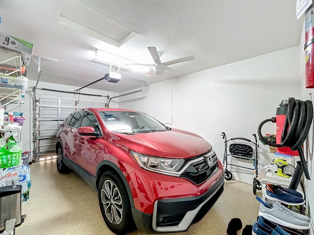 garage with ceiling fan and a garage door opener