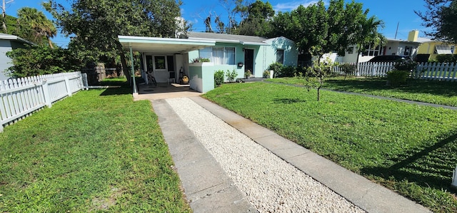 view of front of house featuring a front lawn and a carport