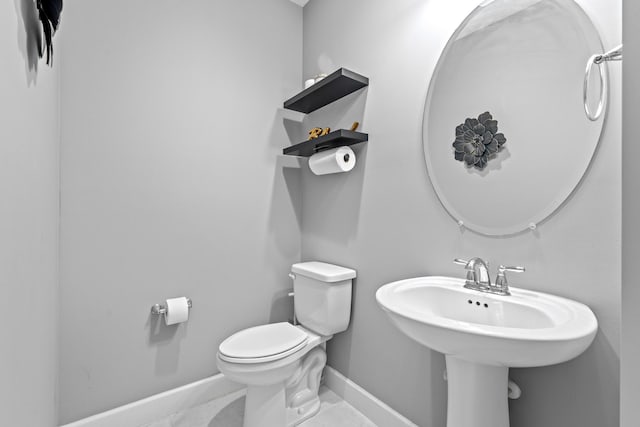 bathroom with tile patterned flooring and toilet