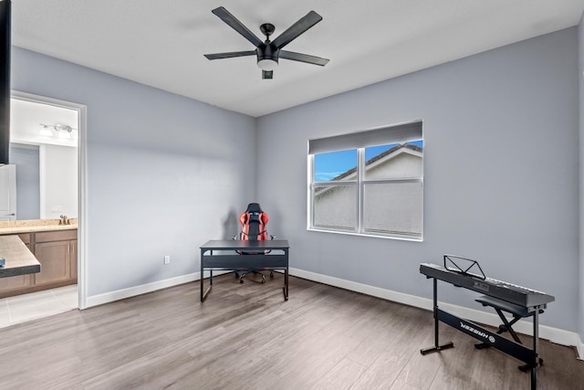 living area with ceiling fan and hardwood / wood-style floors