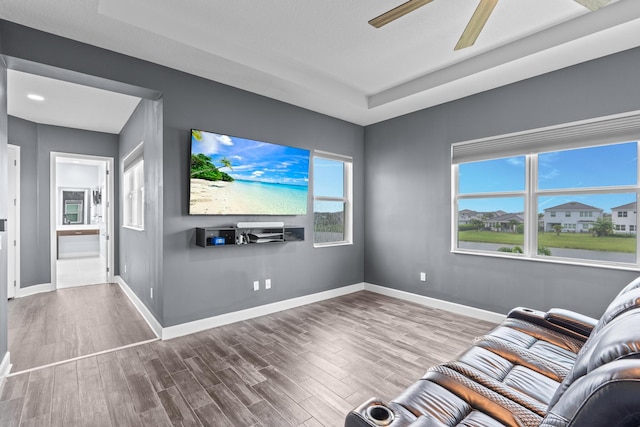 unfurnished living room featuring ceiling fan and wood-type flooring