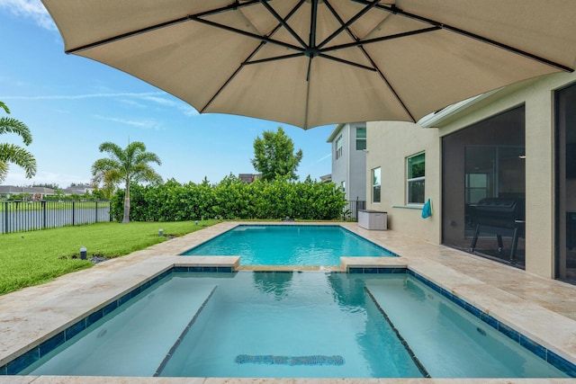 view of swimming pool featuring a lawn and a patio