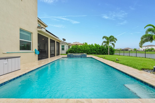 view of swimming pool featuring a lawn and a sunroom