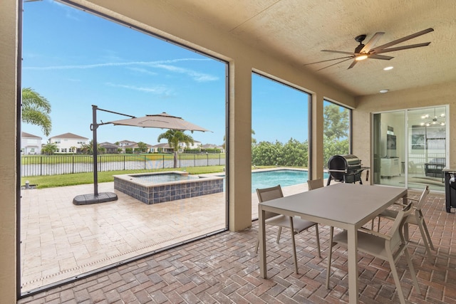 sunroom / solarium featuring ceiling fan