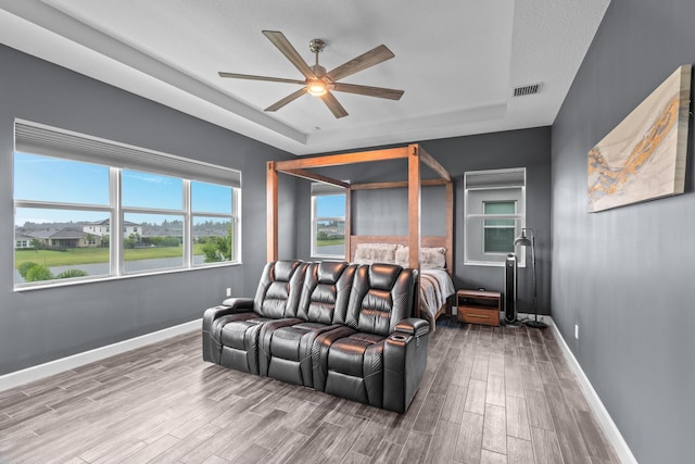 interior space with ceiling fan and wood-type flooring