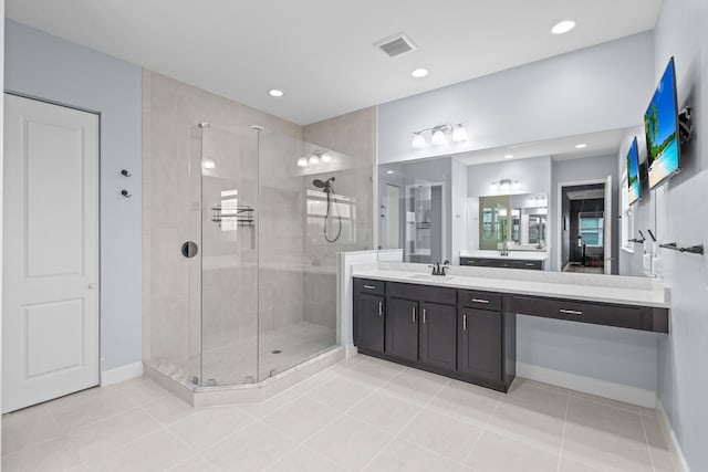 bathroom with tile patterned flooring, an enclosed shower, and vanity