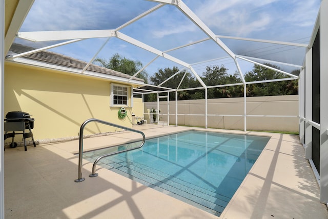 view of pool with a patio and a lanai