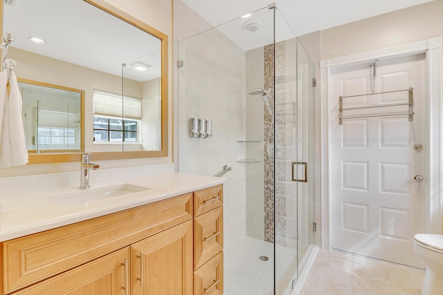 bathroom with walk in shower, toilet, tile patterned floors, and vanity