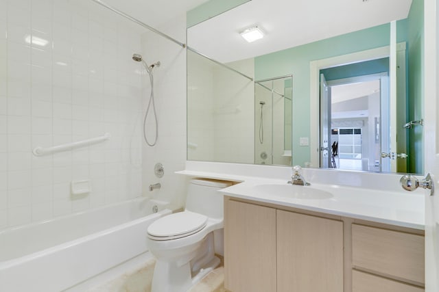 full bathroom with tile patterned floors, vanity, tiled shower / bath combo, and toilet