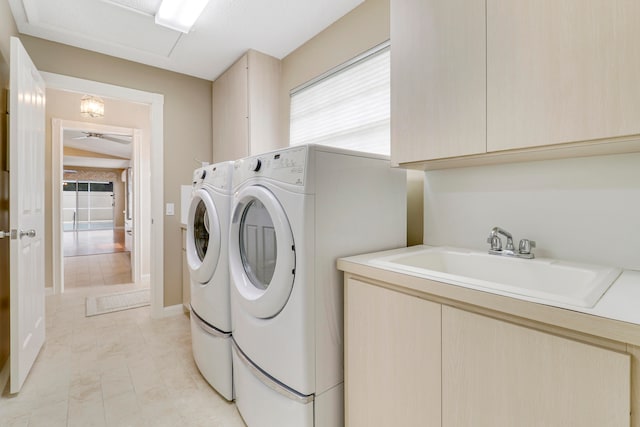 washroom with cabinets, independent washer and dryer, ceiling fan, light tile patterned floors, and sink