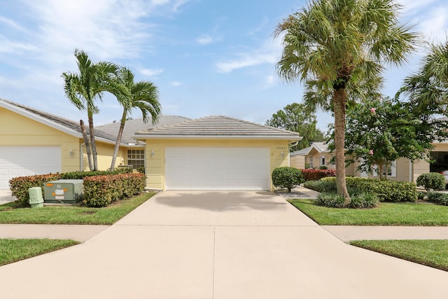 ranch-style house with cooling unit and a garage