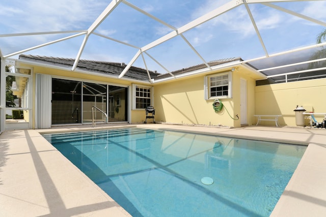 view of pool with glass enclosure