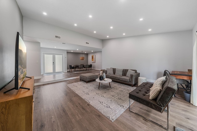 living room with light hardwood / wood-style flooring and french doors