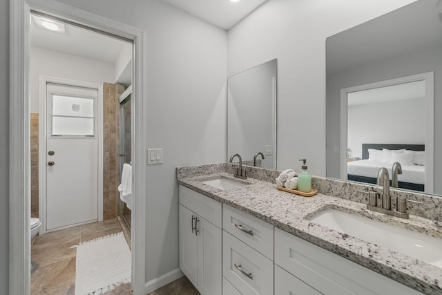 bathroom with a shower with door, double vanity, tile patterned flooring, and toilet